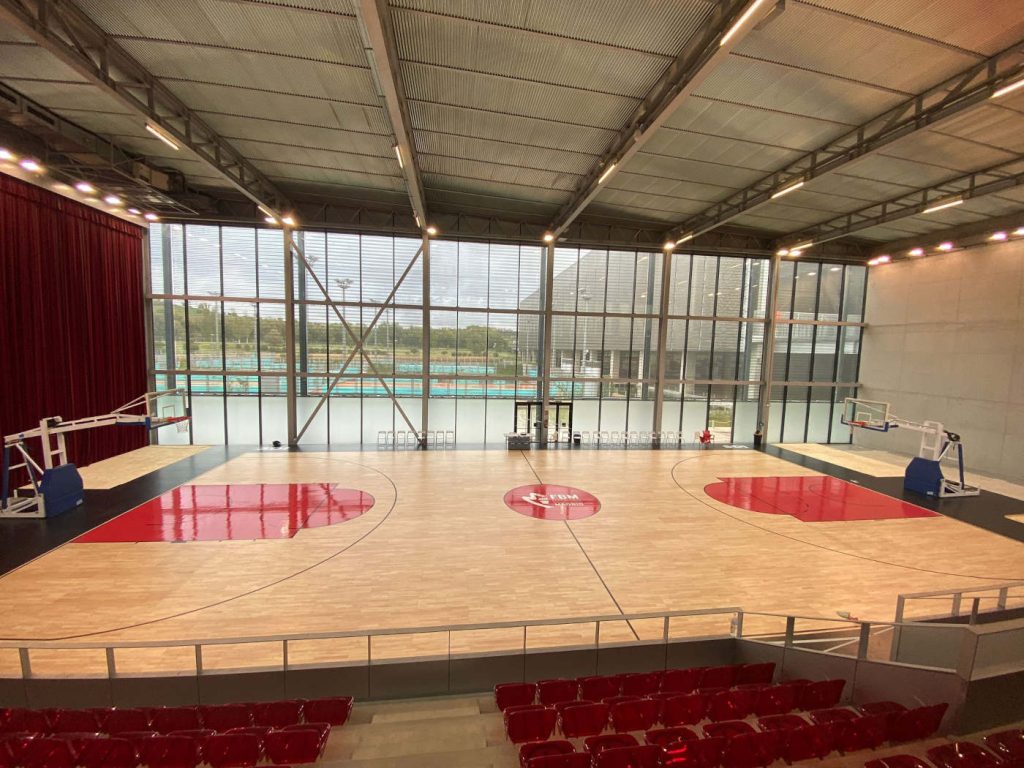 Entrenadores dando indicaciones a un grupo de jugadores en una cancha de baloncesto durante el Basquet Stage. Los alumnos aprenden una manera diferente de aprender baloncesto.